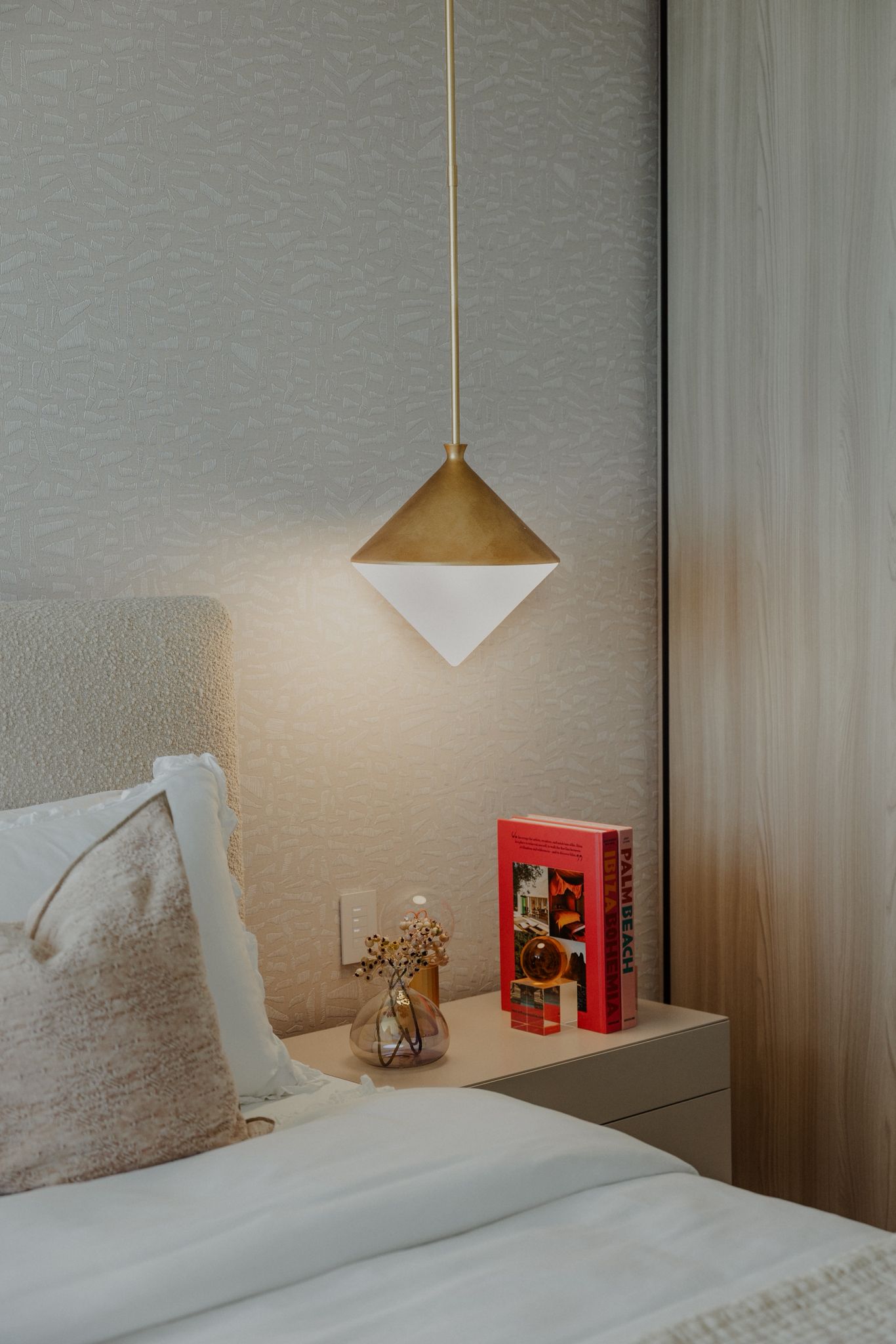 Dining area with golden pendants and amber light.